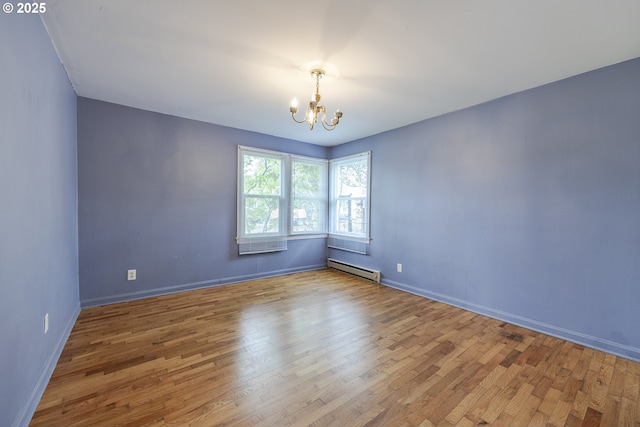 412 W 17th Ave, Eugene, OR 97401 - empty room with a chandelier, wood finished floors, a baseboard heating unit, and baseboards