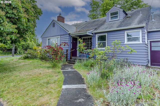 412 W 17th Ave, Eugene, OR 97401 - view of front facade featuring a front lawn, a chimney, and board and batten siding