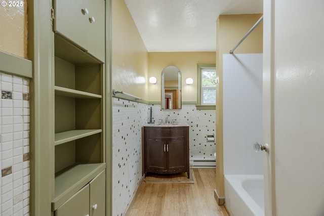 412 W 17th Ave, Eugene, OR 97401 - full bathroom featuring a baseboard radiator, a tub to relax in, vanity, a shower, and a wainscoted wall