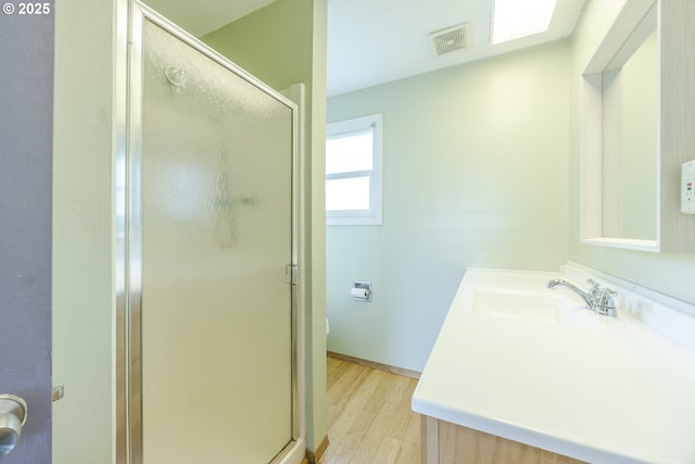 412 W 17th Ave, Eugene, OR 97401 - bathroom with vanity, a stall shower, wood finished floors, and toilet