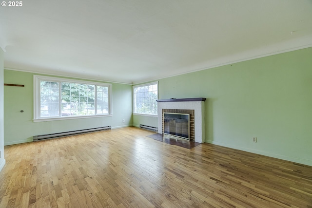 412 W 17th Ave, Eugene, OR 97401 - unfurnished living room featuring a baseboard heating unit, crown molding, wood finished floors, a brick fireplace, and baseboards