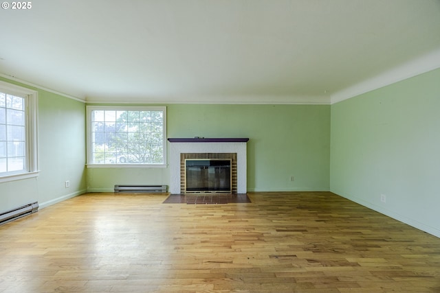 412 W 17th Ave, Eugene, OR 97401 - unfurnished living room featuring a baseboard radiator, wood finished floors, a fireplace, crown molding, and baseboards