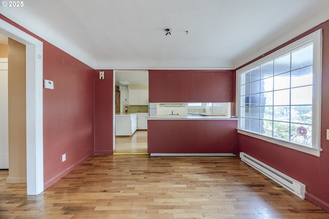 412 W 17th Ave, Eugene, OR 97401 - kitchen with baseboard heating, light wood-style floors, and baseboards