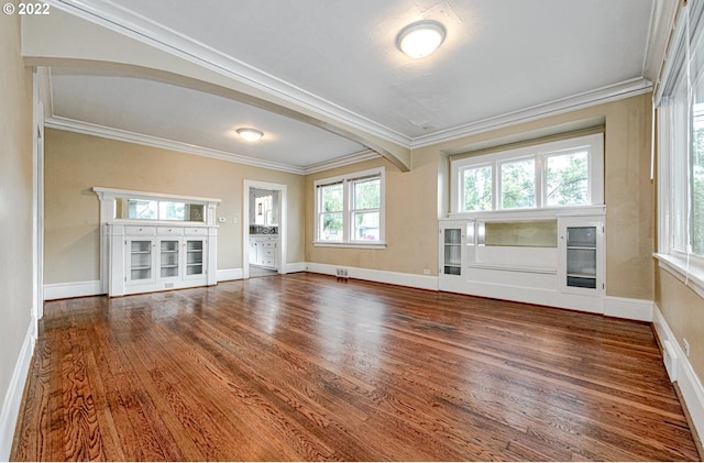 unfurnished living room featuring dark hardwood / wood-style flooring and ornamental molding