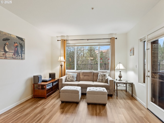 635 NW Lost Springs Ter Unit 104, Portland, OR 97229 - living room featuring light wood-style flooring and baseboards