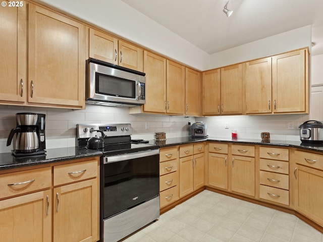 635 NW Lost Springs Ter Unit 104, Portland, OR 97229 - kitchen featuring appliances with stainless steel finishes and light brown cabinets