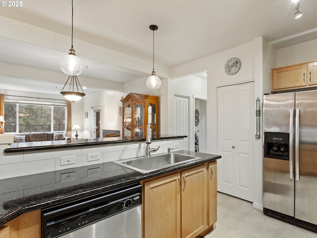 635 NW Lost Springs Ter Unit 104, Portland, OR 97229 - kitchen with stainless steel appliances, dark countertops, a sink, decorative light fixtures, and light brown cabinets