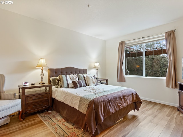 635 NW Lost Springs Ter Unit 104, Portland, OR 97229 - bedroom featuring light wood-style floors and baseboards