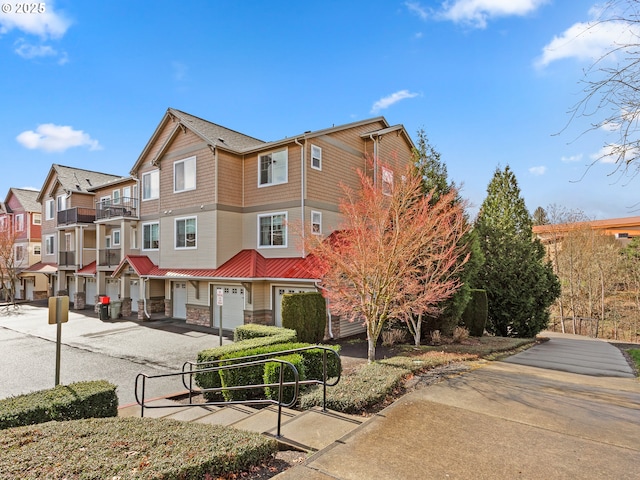 635 NW Lost Springs Ter Unit 104, Portland, OR 97229 - view of property with a residential view, asphalt driveway, and a garage