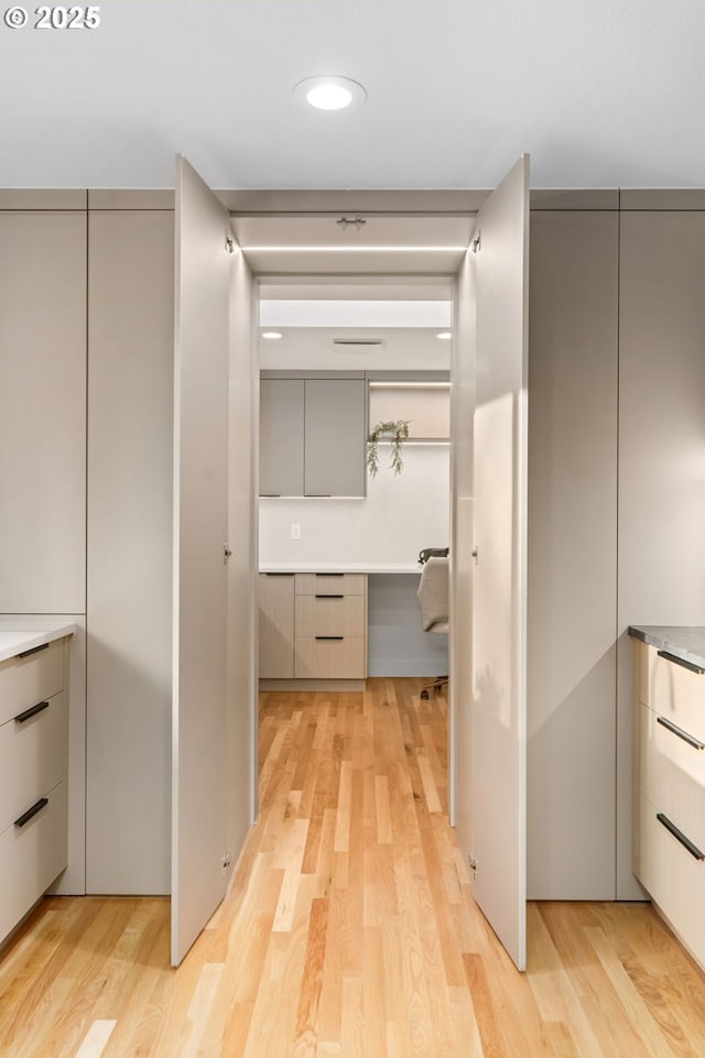 corridor with light hardwood / wood-style floors