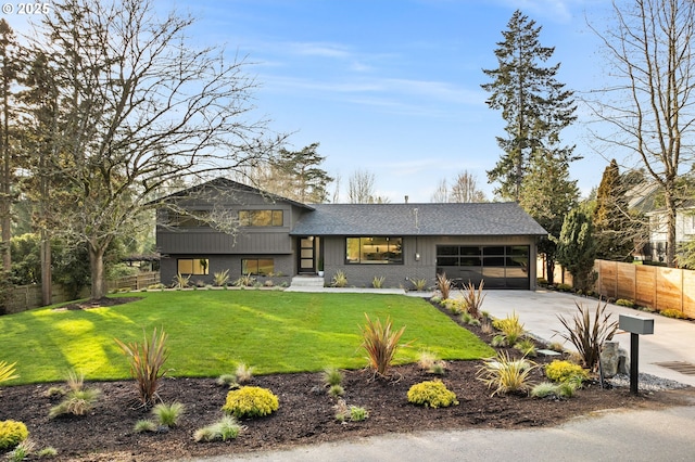 view of front of house with a garage and a front lawn