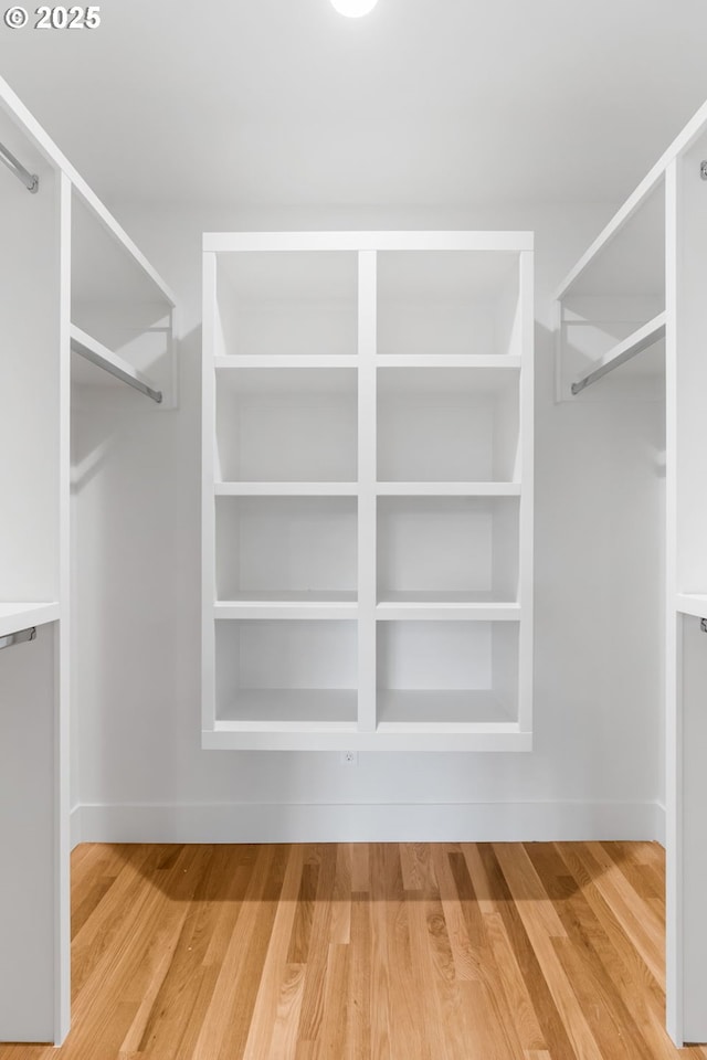 spacious closet featuring hardwood / wood-style floors