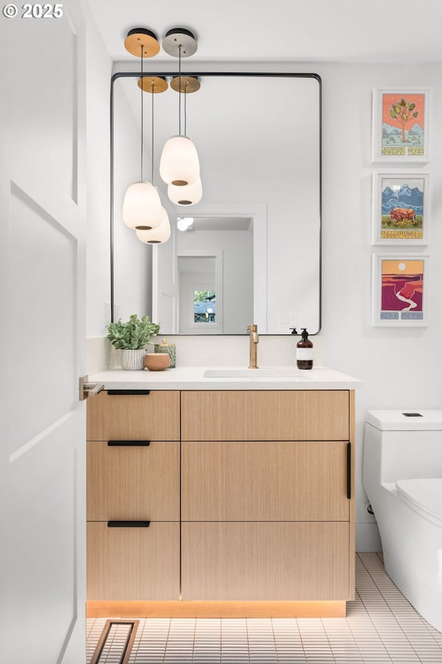 bathroom featuring toilet, tile patterned flooring, and vanity