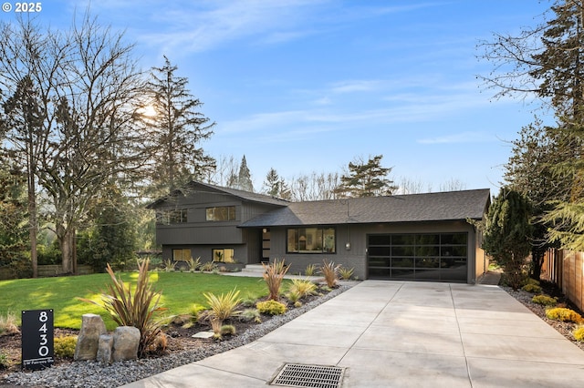 view of front of home with a front lawn and a garage