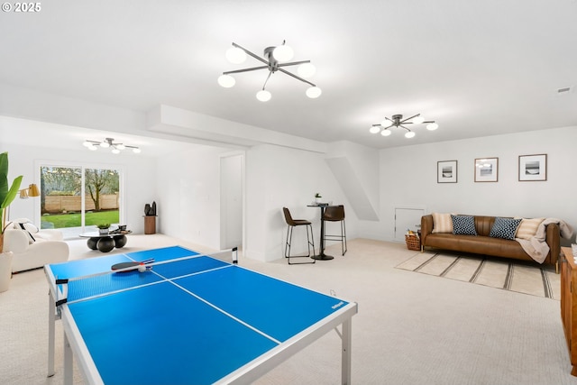 playroom featuring a chandelier and carpet flooring