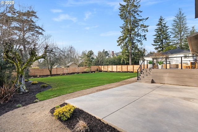 view of yard featuring a patio area and a wooden deck