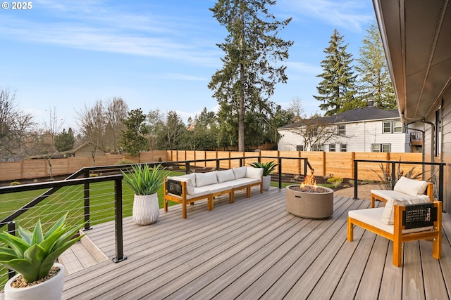 deck with an outdoor living space with a fire pit and a lawn