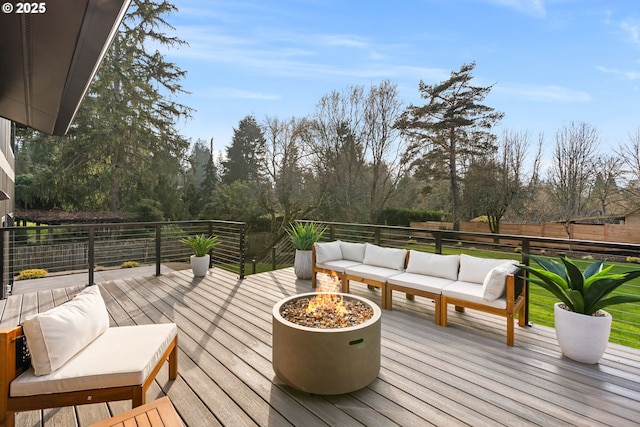 wooden terrace featuring an outdoor living space with a fire pit