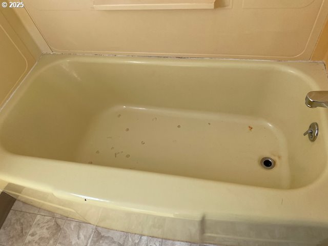 full bathroom featuring a bathtub and tile patterned floors