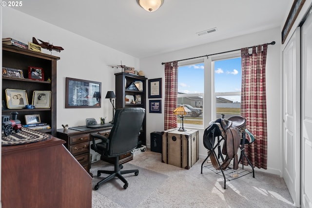 home office with baseboards, visible vents, and light colored carpet