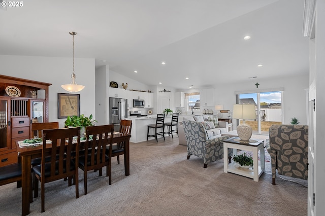 dining area featuring light colored carpet, vaulted ceiling, and recessed lighting
