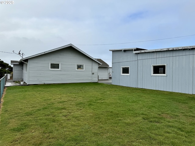 rear view of property featuring a yard