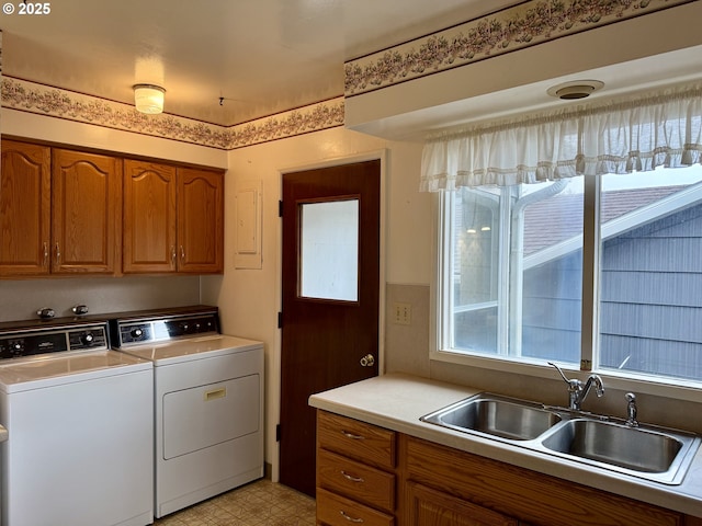 laundry room with cabinets, sink, and washer and clothes dryer