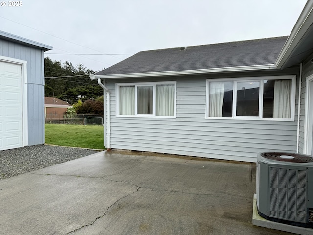 view of side of home with a patio area and central air condition unit