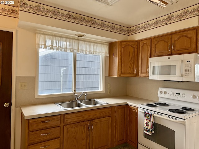 kitchen featuring white appliances and sink