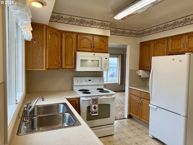 kitchen featuring white appliances and sink