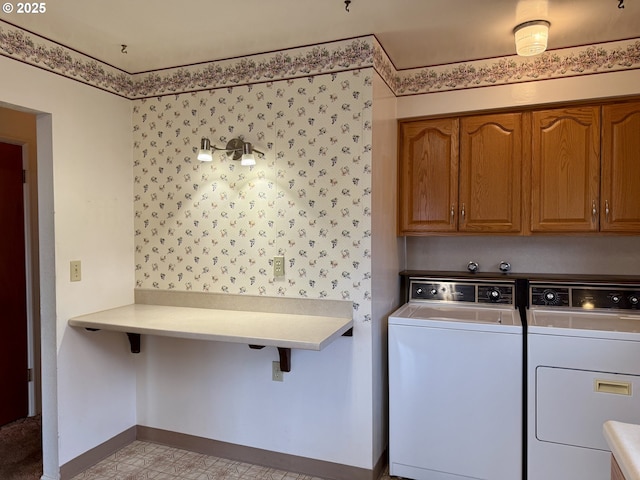 washroom with cabinets and washer and dryer