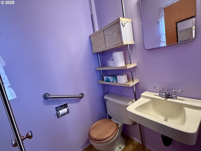 bathroom featuring sink and toilet