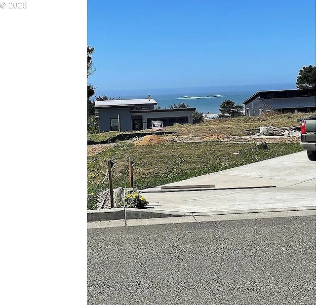 view of front of property with a water view