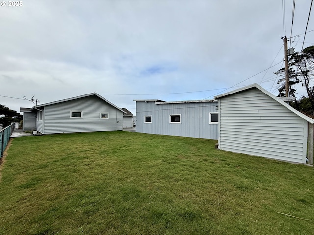 rear view of house featuring a lawn