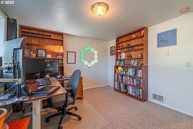 office featuring carpet flooring and a textured ceiling