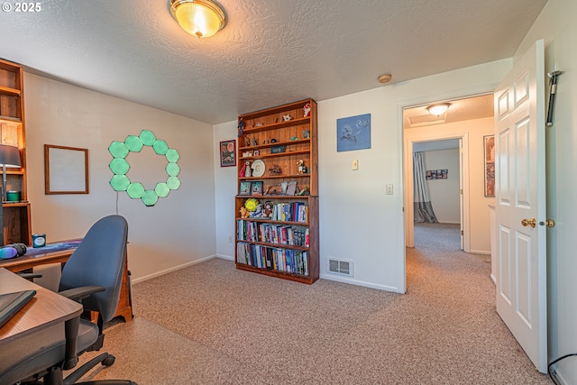 office featuring a textured ceiling and light colored carpet