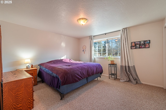 carpeted bedroom featuring a textured ceiling