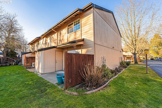 view of property exterior featuring a lawn and a garage