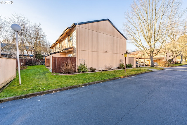 view of side of home featuring a yard