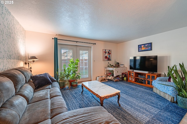 carpeted living room featuring french doors and a textured ceiling