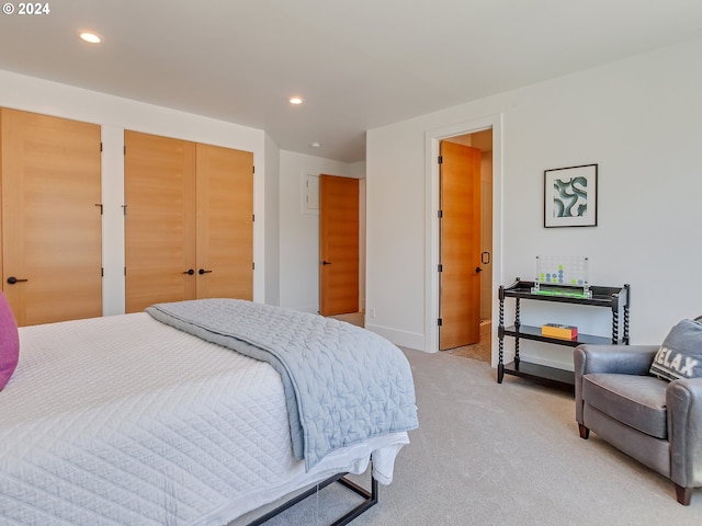 carpeted bedroom with multiple closets