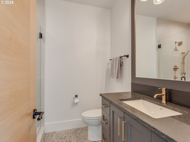 bathroom with toilet, vanity, and walk in shower