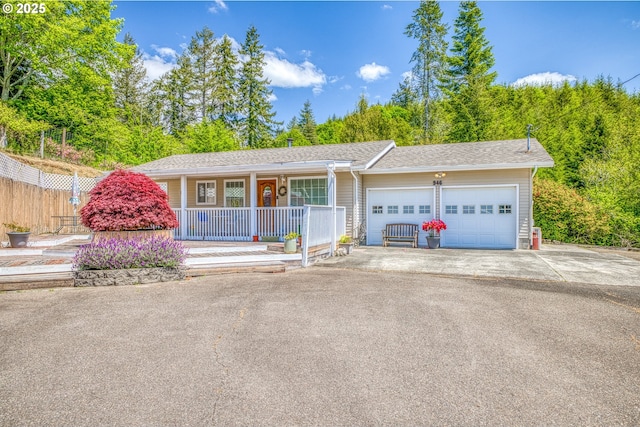 946 E 9th Pl, Coquille, OR 97423 - ranch-style house featuring a porch, an attached garage, asphalt driveway, and roof with shingles