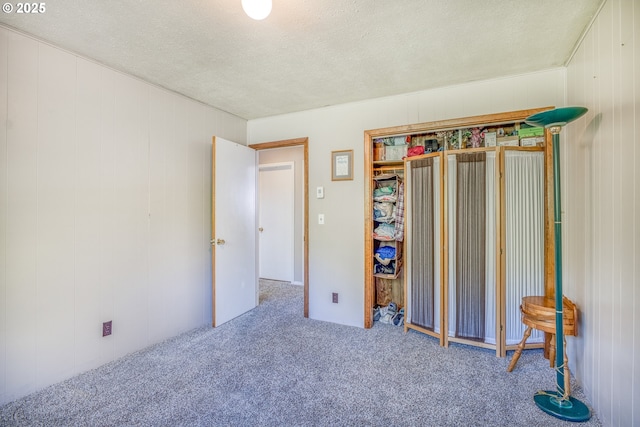 946 E 9th Pl, Coquille, OR 97423 - bedroom featuring carpet flooring, a textured ceiling, and wooden walls