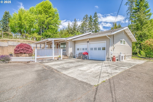946 E 9th Pl, Coquille, OR 97423 - view of front of home featuring covered porch, a garage, central air condition unit, and concrete driveway