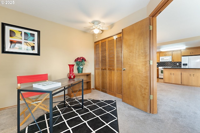 office space featuring light colored carpet and ceiling fan