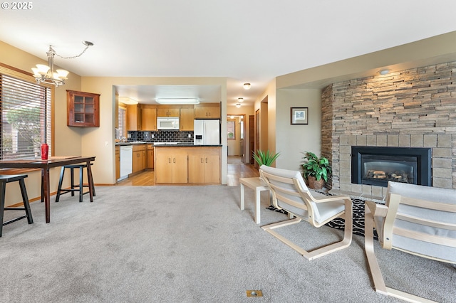 living room with an inviting chandelier and light carpet