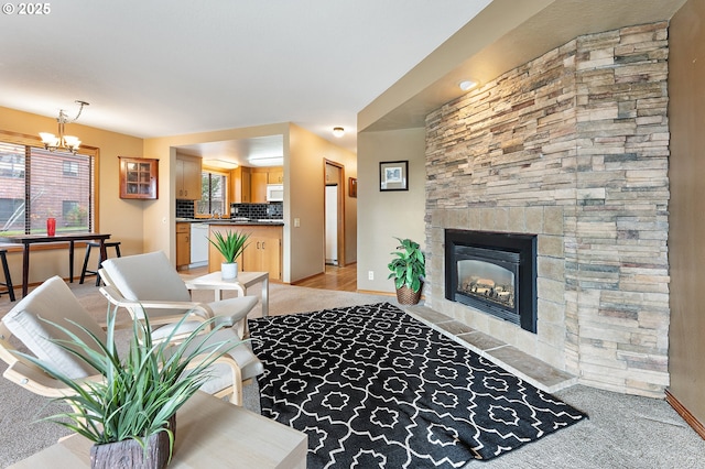 living room featuring an inviting chandelier and a fireplace