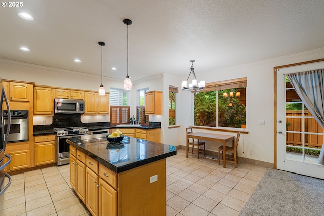 61 SW Wallingford Way, Beaverton, OR 97006 - kitchen featuring appliances with stainless steel finishes, light tile patterned flooring, healthy amount of natural light, crown molding, and a kitchen island