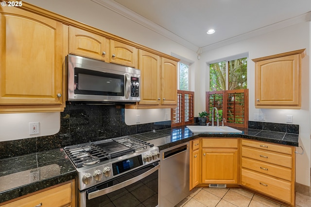 61 SW Wallingford Way, Beaverton, OR 97006 - kitchen featuring stainless steel appliances, a sink, ornamental molding, light tile patterned floors, and tasteful backsplash
